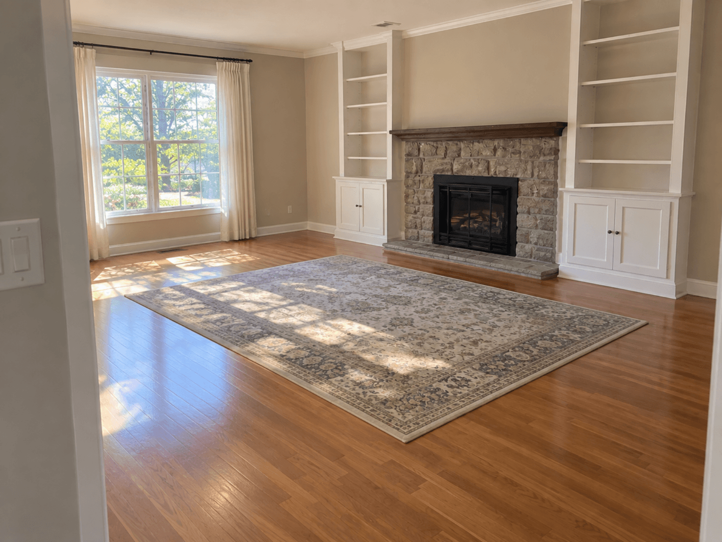 The living room cleared, with only the rug left
